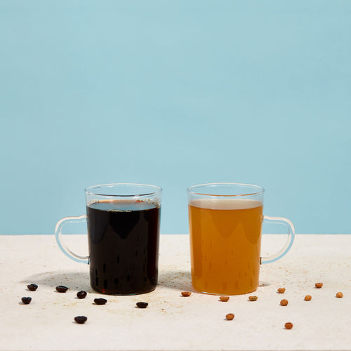 Photo of two clear mugs against a blue background; one contains Golden Ratio gold coffee, the other a regular dark roast.